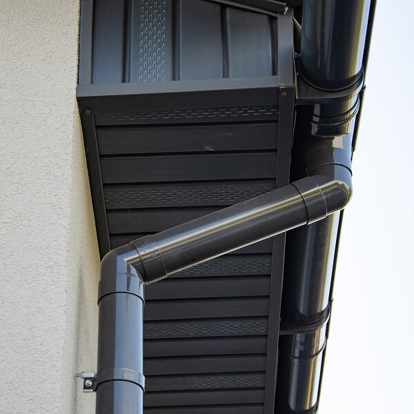 A display of different aluminum gutter sections showing various colors and sleek finishes.