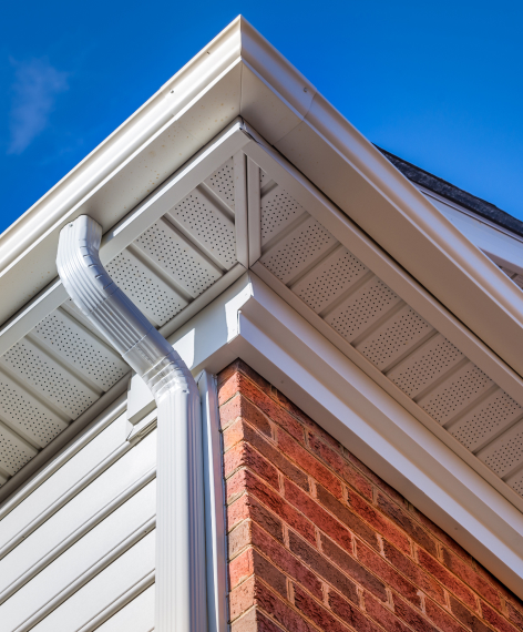 A close up of a house gutter with gutter guards.